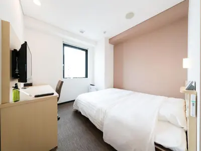 a bedroom with a bed and a desk and a television at Super Hotel Tokyo Kinshicho Ekimae / Vacation STAY 78889 in Tokyo