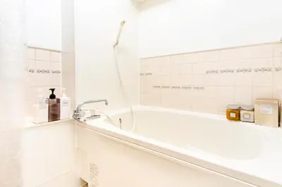 a white bathroom with a tub and a sink at HARMONIA\u6771\u4eac\u6e0b\u8c37 shibuya in Tokyo