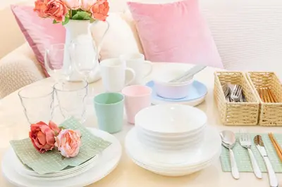 a table with plates and dishes and a vase with flowers at HARMONIA\u6771\u4eac\u6e0b\u8c37 shibuya in Tokyo