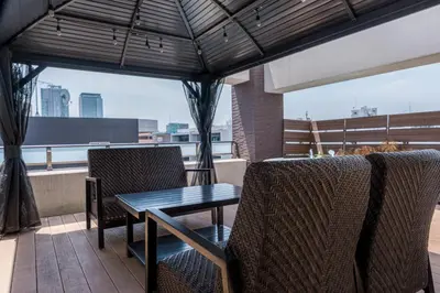 a table and chairs on a balcony with a view at Oshiage Sky View Terrace Penthouse - brand new Hot Tab installed in 2025- in Tokyo