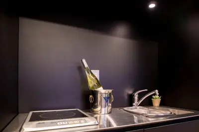 a kitchen counter with a sink with a bottle of wine at Oshiage Sky View Terrace Penthouse - brand new Hot Tab installed in 2025- in Tokyo