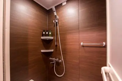 a bathroom with a shower with wooden walls at Oshiage Sky View Terrace Penthouse - brand new Hot Tab installed in 2025- in Tokyo