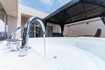 a sink with two faucets on a bath tub at Oshiage Sky View Terrace Penthouse - brand new Hot Tab installed in 2025- in Tokyo
