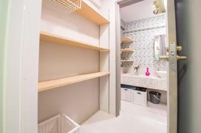 a small bathroom with a sink and a mirror at AZEGAMI 2F in Tokyo