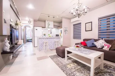 a living room with a couch and a table at AZEGAMI 2F in Tokyo