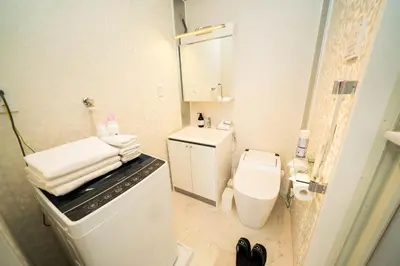 a white bathroom with a toilet and a sink at CASA VERDE Shinjuku# 1K in Tokyo