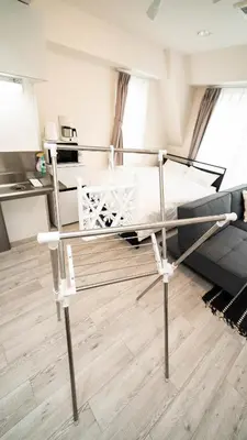a metal bed in a room with a couch at CASA VERDE Shinjuku# 1K in Tokyo