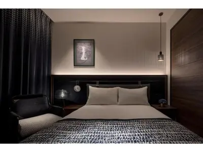 a bedroom with a large bed and a chair at THE LIVELY AZABUJUBAN TOKYO / Vacation STAY 77702 in Tokyo