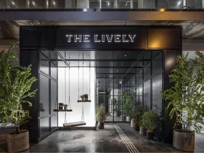 an entrance to the lobby of a building with potted plants at THE LIVELY AZABUJUBAN TOKYO / Vacation STAY 77702 in Tokyo