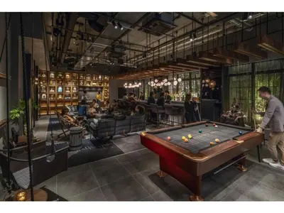 a man standing in a room with a pool table at THE LIVELY AZABUJUBAN TOKYO / Vacation STAY 77702 in Tokyo