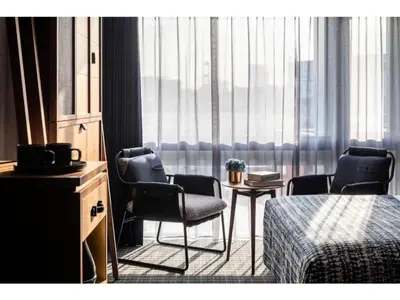 a room with chairs and a table and a window at THE LIVELY AZABUJUBAN TOKYO / Vacation STAY 77702 in Tokyo
