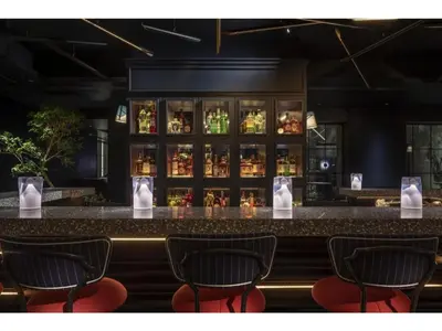 a bar with four chairs in front of a counter at THE LIVELY AZABUJUBAN TOKYO / Vacation STAY 77707 in Tokyo