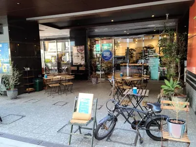 a bike parked outside of a store with tables and chairs at APA Hotel Nihombashi Bakuroyokoyama Ekimae in Tokyo