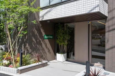 a street sign in front of a building at Eisei Stay in Tokyo