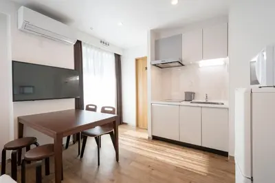 a kitchen and dining room with a table and chairs at Eisei Stay in Tokyo