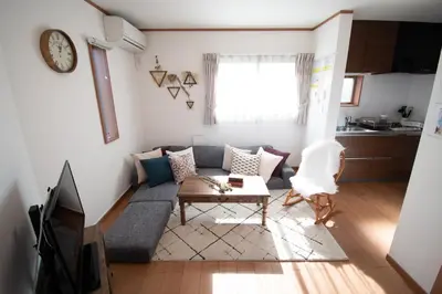 a living room with a couch and a table at Ritz Residence \u58a8\u7530 in Tokyo