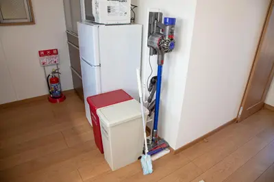 a room with a white refrigerator and a camera at Ritz Residence \u58a8\u7530 in Tokyo