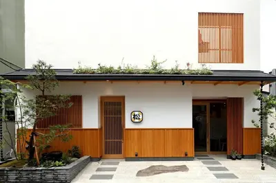 a white building with plants on the roof at Hotel Matsunoi in Tokyo