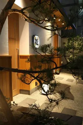 a view of a building with a tree in the foreground at Hotel Matsunoi in Tokyo