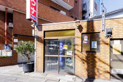 a store front with a glass door on a brick building at Maison d'Orme 503 in Tokyo