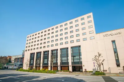 a large white building on the side of a street at Hotel Grand Hill Ichigaya in Tokyo