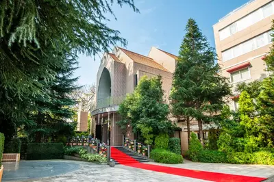a red carpet in front of a building with trees at Hotel Grand Hill Ichigaya in Tokyo