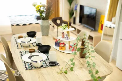 a wooden table with plates and food on it at \u5bc5\u30db\u30c6\u30eb \u53f0\u6771 Hotel \u5bc5 \u53f0\u4e1c Tora Hotel Taito C in Tokyo