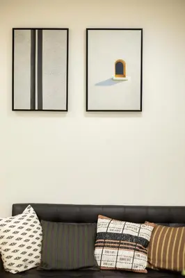 a living room with a couch and two framed pictures at \u5bc5\u30db\u30c6\u30eb \u53f0\u6771 Hotel \u5bc5 \u53f0\u4e1c Tora Hotel Taito C in Tokyo