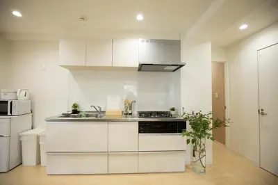 a kitchen with white cabinets and a stove at \u5bc5\u30db\u30c6\u30eb \u53f0\u6771 Hotel \u5bc5 \u53f0\u4e1c Tora Hotel Taito C in Tokyo