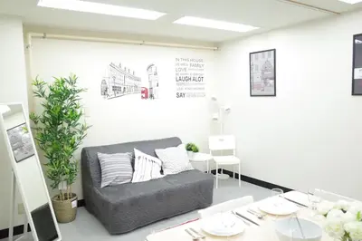 a living room with a couch and a table at \u5bc5\u30db\u30c6\u30eb \u53f0\u6771 Hotel \u5bc5 \u53f0\u4e1c Tora Hotel Taito A in Tokyo