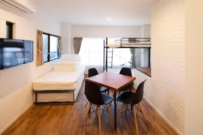 a room with a bed and a table and chairs at HOTEL LITTLE BIRD OKU-ASAKUSA / Vacation STAY 79431 in Tokyo