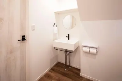 a white bathroom with a sink and a mirror at HOTEL LITTLE BIRD OKU-ASAKUSA / Vacation STAY 79431 in Tokyo