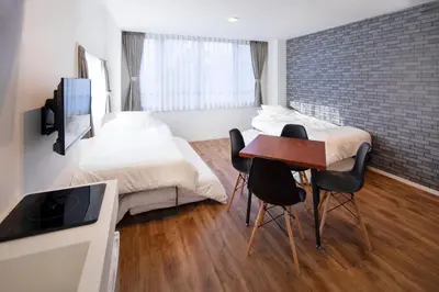 a bedroom with a bed and a table and chairs at HOTEL LITTLE BIRD OKU-ASAKUSA / Vacation STAY 79448 in Tokyo