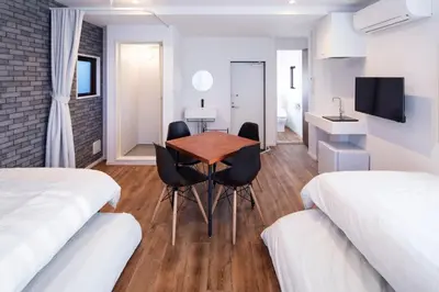 a hotel room with two beds and a table and chairs at HOTEL LITTLE BIRD OKU-ASAKUSA / Vacation STAY 79448 in Tokyo