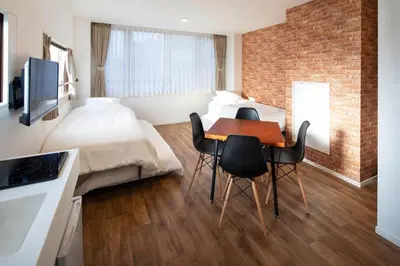 a bedroom with a bed and a table and chairs at HOTEL LITTLE BIRD OKU-ASAKUSA / Vacation STAY 79446 in Tokyo