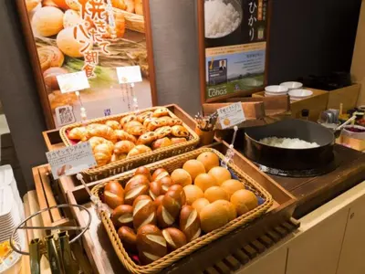 a bakery counter with baskets of bread and other pastries at Super Hotel Tokyo Kinshicho Ekimae / Vacation STAY 79355 in Tokyo
