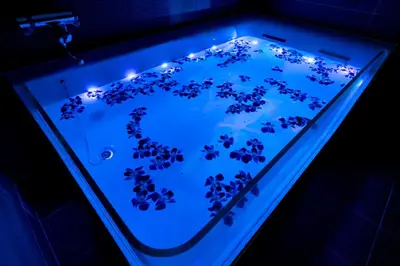 a blue glass tank with flowers in it at Hotel Lotus Koiwa (Adult Only) in Tokyo