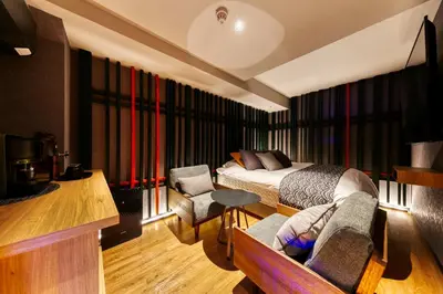 a bedroom with a bed and a couch and a table at Hotel Lotus Koiwa (Adult Only) in Tokyo