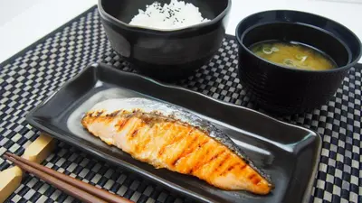 a plate with a piece of fish and a bowl of soup at Hotel Lotus Koiwa (Adult Only) in Tokyo