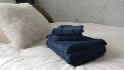 a blue towel sitting on top of a bed at Asakusa Sky Stay Tiffany blue Room in Tokyo