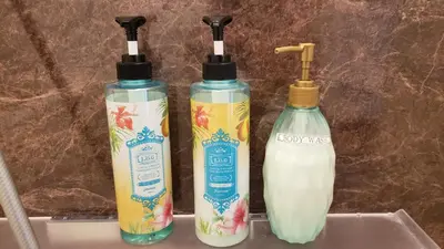 three bottles of milk sitting on top of a sink at Asakusa Sky Stay Tiffany blue Room in Tokyo