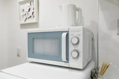 a microwave oven sitting on top of a counter at Asakusa Sky Stay Tiffany blue Room in Tokyo