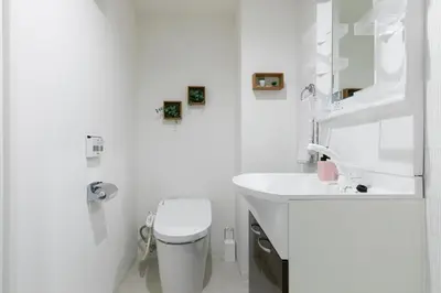 a white bathroom with a toilet and a sink at Asakusa Sky Stay Tiffany blue Room in Tokyo