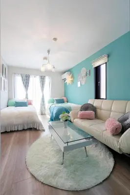 a living room with a couch and a table at Asakusa Sky Stay Tiffany blue Room in Tokyo