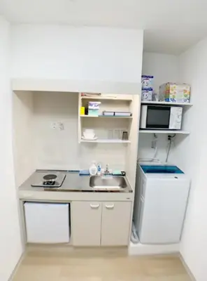 a small kitchen with a sink and a microwave at Sunstay - Higashi-Nakano in Tokyo