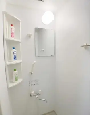 a bathroom with a shower with a mirror and a sink at Sunstay - Higashi-Nakano in Tokyo