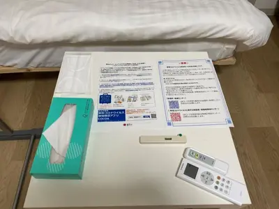 a box with a thermometer and a remote control on a table at Sunstay - Higashi-Nakano in Tokyo
