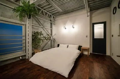 a bedroom with a white bed and a large window at prosperityta Yutaka 2F / Vacation STAY 80031 in Tokyo