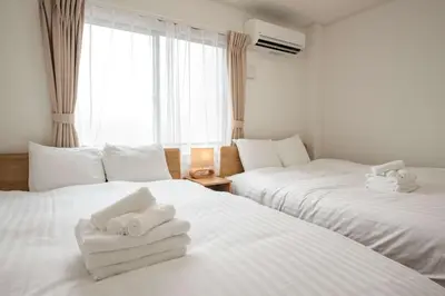 two beds in a room with white towels on them at Noah Ikebukuro / Vacation STAY 7297 in Tokyo