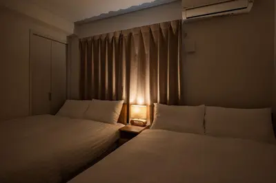 two beds in a small room with a window at Noah Ikebukuro / Vacation STAY 7297 in Tokyo